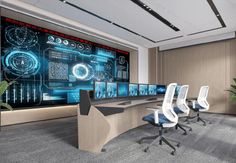 a conference room with multiple monitors and chairs