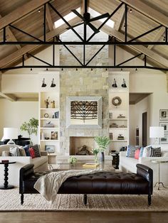 a living room filled with lots of furniture and a fire place in the middle of it