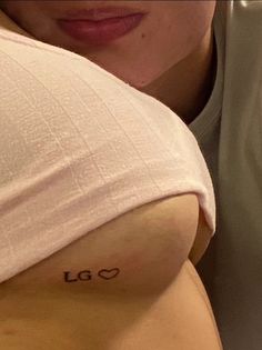 a woman with a tattoo on her left arm and the word love is written in cursive font