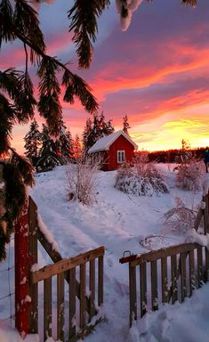 a red house sitting on top of a snow covered field