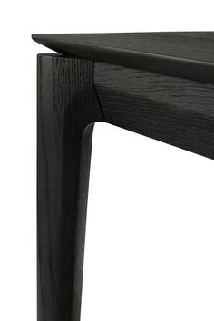 a close up of a wooden table with black woodgrain on the top and bottom