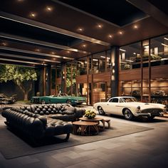 two classic cars parked in front of a building with glass walls and floor to ceiling windows