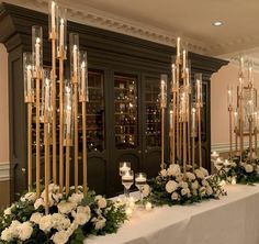 a long table with candles and flowers on it