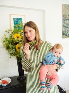 a woman holding a baby in her arms