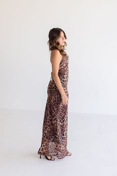 Get ready to pounce on style in the Rebecca Midi Dress. With its playful leopard print and sassy sleeveless design, this dress is perfect for date night. Don't forget the cowl neckline with back tie closure for an extra touch of charm. Style with strappy heels and a clutch. Details + Fit 100% Polyester Runs True to Size Hand Wash Cold Hang Dry Cowl Neckline Sleeveless Adjustable Shoulder Straps Back Tie Closure Side Zipper Closure Lined Leopard Print Design Brown | Multi | Printed Model is 5'2" Sleeveless Leopard Print Beach Dresses, Chic Sleeveless Leopard Print Dress, Chic Leopard Print Sleeveless Dress, Sleeveless Brown Tiger Print Dress, Sleeveless Leopard Print Party Dress, Brown Sleeveless Tiger Print Dress, Sleeveless Leopard Print Evening Dress, Leopard Print Fitted Maxi Dress For Date Night, Fitted Leopard Print Maxi Dress For Date Night