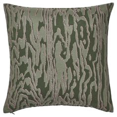 a green and pink pillow with an animal print pattern on the front, along with a white background