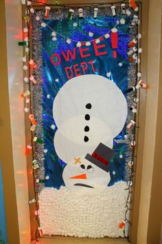 a decorated door with a snowman on it's face and words over the top