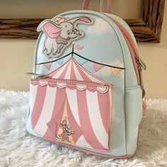 -Authentic, Brand New With Tags Loungefly Disney Dumbo Circus Tent Mini Backpack - This Item Is Sold Out On Site! -You Will Receive The Exact Bag Pictured. -Super Cute, A Fantastic Piece To Take To The Parks Or Even As An Everyday Bag! :) -Comes From A Clean, Smoke Free, Pet Free Home. -I Ship Within 1-2 Days From Purchase. -Please Request For More Photos If Needed. -Check Out My Other Items! Bundle To Save On Shipping. Cute Standard Backpack For Theme Parks, Cute Standard Backpack For Theme Park, Playful Backpack For Theme Park, Pineapple Backpack, Loungefly Purse, Disney Bags Backpacks, Circus Tent, Loungefly Bag, Woody Toy Story