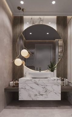 a bathroom with marble counter tops and a round mirror