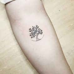 a small tree tattoo on the left arm