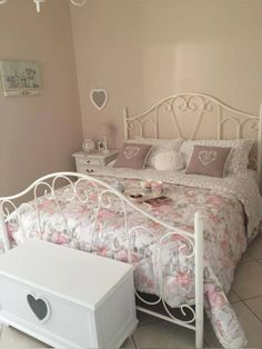 a white bed sitting in a bedroom next to a dresser