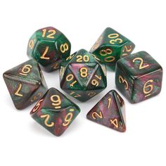 seven green and gold dice with numbers on them, sitting in front of a white background