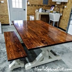 a kitchen table made out of wood with white legs and an x - leg base