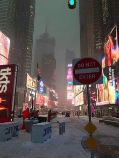 a city street filled with lots of traffic and tall buildings covered in neon billboards