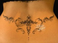 the back of a woman's stomach with an intricate design on her lower side