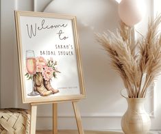 a welcome sign next to a vase with flowers