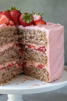 there is a cake that has been cut in half with strawberries on the top