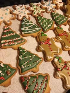 many decorated christmas cookies on a table