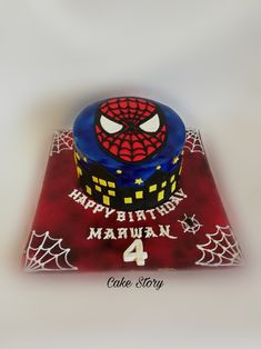 a spiderman birthday cake with the number four on it's top and web