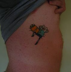 a person with a small tattoo on their leg that has a cartoon character on it