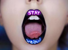 a woman's tongue with the words stay weird painted on it and her tongue sticking out