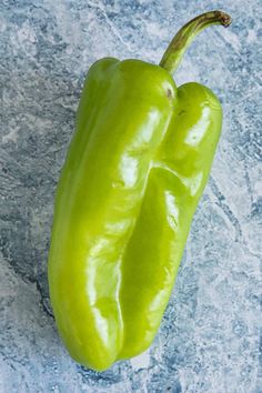 two green peppers sitting on top of each other