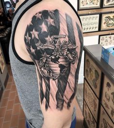 a man with an american flag and eagle tattoo on his arm