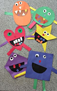 paper bag puppets with faces and mouths on the floor in front of a carpeted area