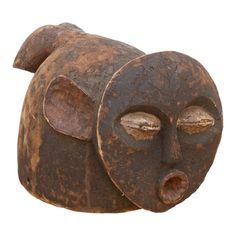 an old wooden sculpture with two faces on it's face and one has eyes closed