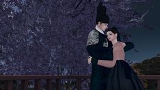 a man and woman dressed in black embracing each other on a deck at night time