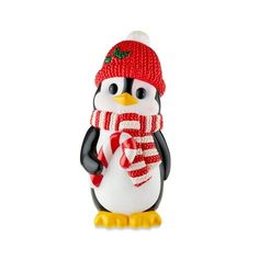 a penguin figurine wearing a red hat and scarf with candy canes on it's feet