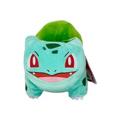 a stuffed toy with a green leaf on it's head and red eyes, sitting in front of a white background