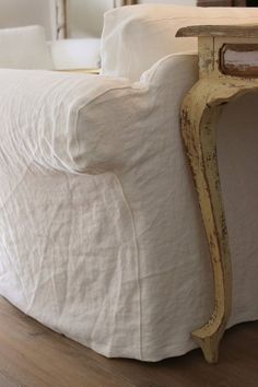 a white bed with a wooden headboard and foot board