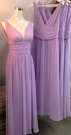 two purple bridesmaid dresses are on display