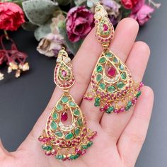 Featuring a traditional jadau necklace embellished with fine quality rubies, emeralds and pearls. This handcrafted piece of luxury has been crafted in 22ct gold. The necklace weighs 32.14 GMs including 1.29 GMs of hanging ruby emerald beads. The earrings weigh 22.87 GMs including3.4 GMs of ruby emerald beads. The intricate detailing perfectly complements traditional Indian attire, designed to be admired for generations to come. It's an exquisite representation of Indian culture and heritage. Traditional Emerald Kundan Necklace For Festivals, Traditional Emerald Kundan Necklace For Celebrations, Traditional Kundan Necklace With Meenakari And Emerald, Chandbali Emerald Necklace With Meenakari For Celebration, Chandbali Meenakari Emerald Necklace For Celebration, Green Ruby Jewelry, Traditional Hand Set Emerald Necklace, Emerald Temple Jewelry Bridal Necklace, Traditional Kundan Emerald Necklace For Festivals