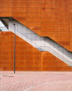 an orange building with stairs leading up to the top and below it is a red fire hydrant