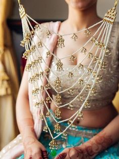 a woman in a blue and white outfit with gold jewelry