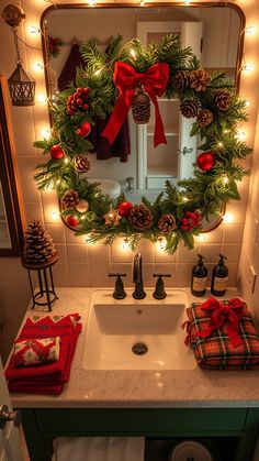 a christmas wreath is hung over a bathroom sink