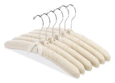 six hangers are hanging on the clothes rack with white cloths attached to them