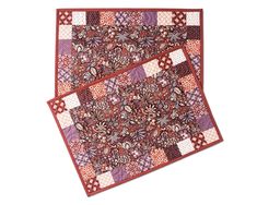 two pieces of red and purple quilted material