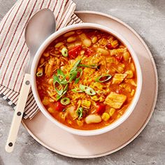 a white bowl filled with soup on top of a table