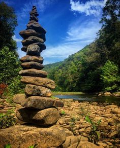 a stack of rocks sitting on top of a river