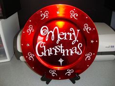 a merry christmas plate sitting on top of a counter next to a toaster oven