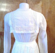 "Edwardian lingerie dress. Sheer white fabric with gorgeous lace inserts and trim. Wide sailor style collar . Bodice opens to a deep v. Front and back apron like panels. This is in such great condition for a dress that's 100 years old. No stains or holes. I made one repair to a break in the insert lace in one of the lower tiers of the skirt. All the hook and eye closures are missing so you will need to add them. Shown on my mannequin 34 1/2\" bust, 26\" waist. 36\" hips My measurement taken flat Fitted White Victorian Cotton Dress, White Vintage Victorian Dress With Lace Work, Vintage White Victorian Dress With Lace Collar, White Cotton Victorian Dress With Lace Trim, Philippine Women, Edwardian Insertion Lace Dress, Lawn Dress, Lingerie Dress, Sailor Fashion