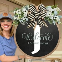 a woman standing next to a welcome sign