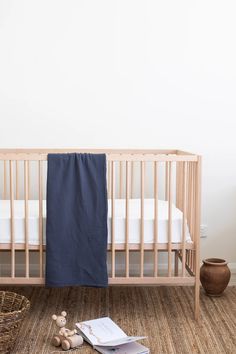 a baby crib with an open book on the floor