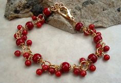 "This delicate bracelet features beautiful clusters of small 4mm red coral natural stones, all metal plated in 24 karat gold. The piece is finished with a lobster closure. The bracelet measures 8\" in length. Adjustments can be made by connecting to any jump ring along the chain. Also available in sterling silver plate." Elegant Red Bracelets With Gold Beads, Gold Red Coral Bracelets For Gifts, Gold Red Coral Bracelets As Gift, Gold Red Coral Bracelet As A Gift, Gold Bracelets With Red Coral As Gift, Gold Red Coral Bracelet For Gift, Red Coral Stone, Cluster Bracelet, Cluster Bracelets