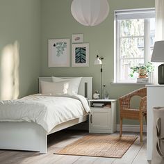 a bedroom with light blue walls and wooden bed frame, pink comforter on the bottom