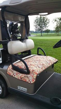 a golf cart is parked in the grass