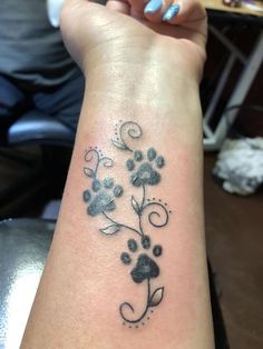 a woman's arm with a flower tattoo on it